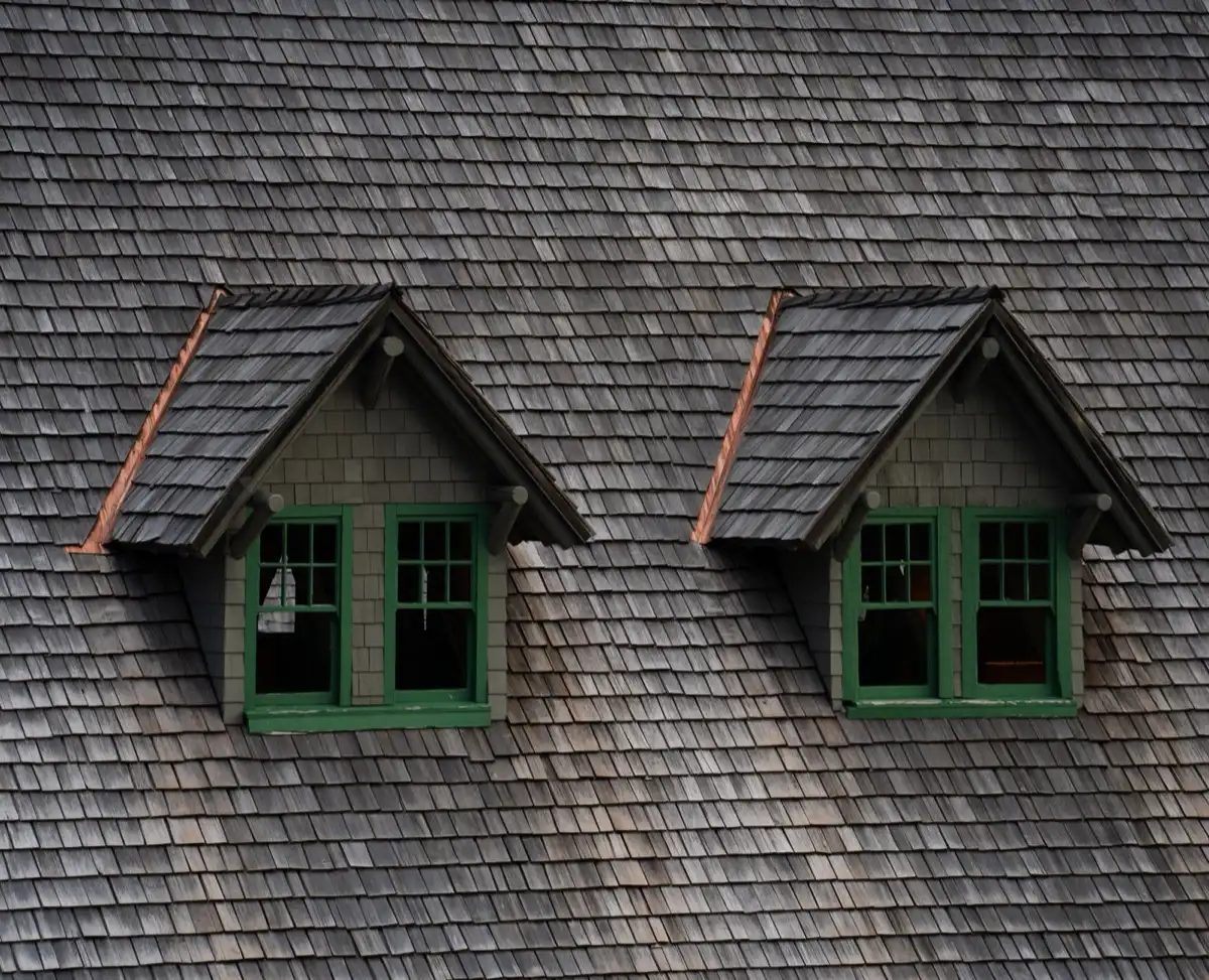 Dormers on a shingle roof in Muncie, IN, where step flashing and kickout flashing carry water past the walls